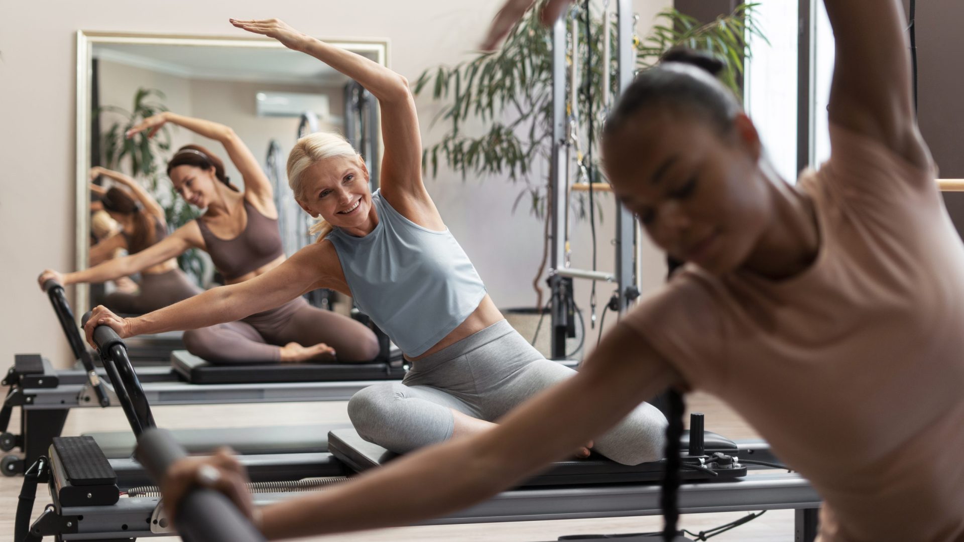 people-pilates-reformer-class-exercising-their-bodies